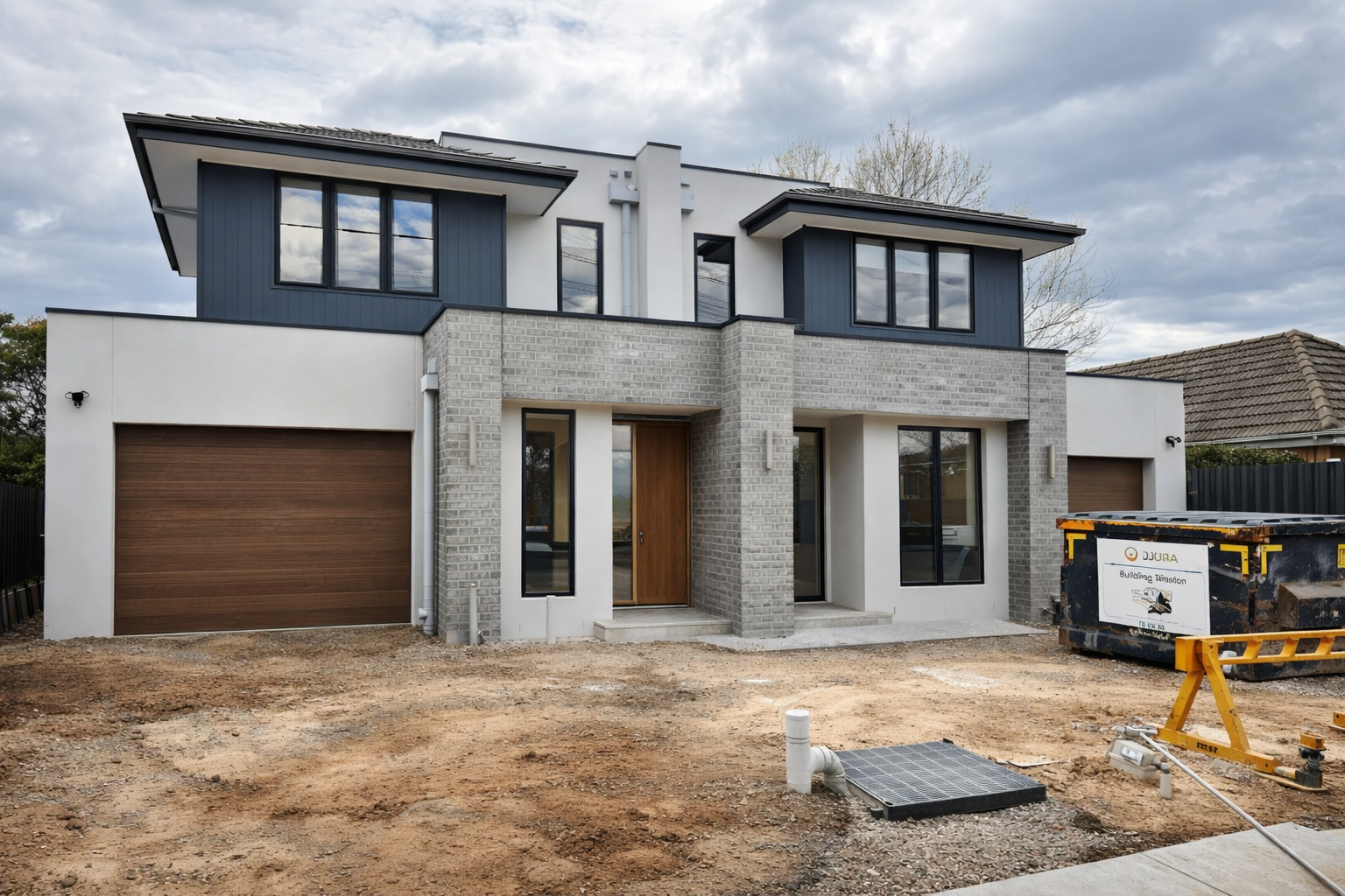 Modern home under construction with landscaping in progress